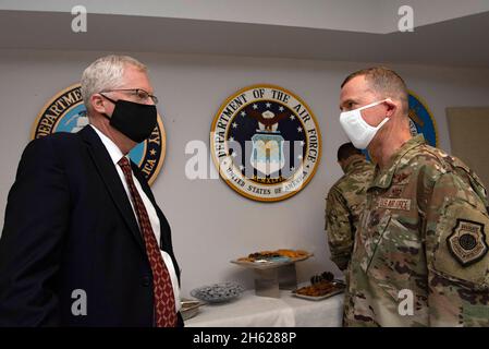 Reportage:  Acting Defense Secretary Christopher C. Miller talks with the commander of Air Forces Central Command, Air Force Lt. Gen. Gregory Guillot, during a Thanksgiving troop meeting at Al Udeid Air Base, Qatar, Nov. 26, 2020. Stock Photo