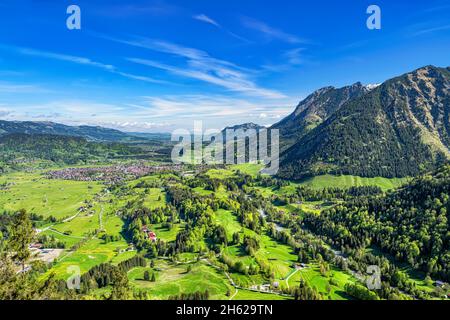 view of the illertal and oberstdorf on a sunny day in spring. green meadows,forests and mountains under a blue sky. allgäu alps,bavaria,germany,europe Stock Photo
