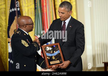 Reportage:   Command Sgt. Maj. Louis Wilson of the New York Army National Guard accepts the Medal of Honor on behalf of World War I Pvt. Henry Johnson, who served with the 369th Infantry Regiment, known as the Harlem Hellfighters, at the White House, Washington, D.C., June 2, 2015. Stock Photo