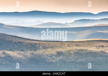 tuscan landscape,morning with fog in the valleys and rolling hills of the crete senesi,asciano,province of siena,tuscany,italy Stock Photo