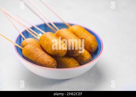 Corn dog cooked with sausage and wheat dough with the addition of corn flour, side view Stock Photo