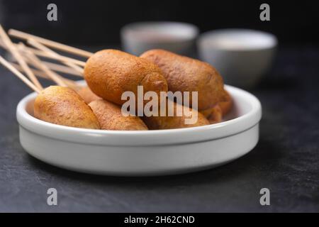 Corn dog cooked with sausage and wheat dough with the addition of corn flour, horizontal Stock Photo