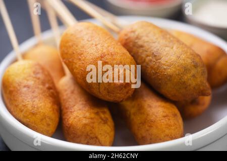 Stack of Corn dog cooked with sausage and wheat dough with the addition of corn flour Stock Photo