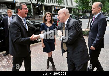 Deputy Secretary of Defense Ashton Carter, left, is greeted by Thomas Donnelly of the American Enterprise Institute May 30, 2012. Stock Photo