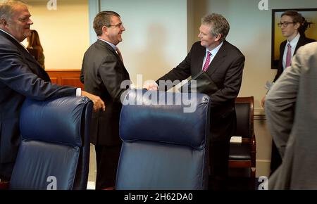 Deputy Secretary of Defense Ashton B. Carter, left, welcomes Australian Secretary of Defense Duncan Lewis to the Pentagon July 13, 2012. Stock Photo