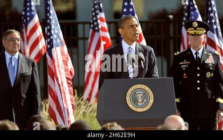 President Barack Obama speaks during a remembrance ceremony at the Pentagon Memorial Sept. 11, 2012. At left is Secretary of Defense Leon E. Panetta; at right is Chairman of the Joint Chiefs of Staff Army Gen. Martin Dempsey. Terrorists hijacked four passenger aircraft Sept. 11, 2001. Two of the aircraft were deliberately crashed into the World Trade Center in New York; one was crashed into the Pentagon; the fourth crashed near Shanksville, Pa. Nearly 3,000 people died in the attacks. Stock Photo