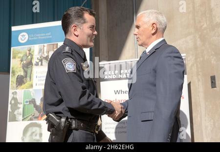 U.S. Customs and Border Protection Deputy Commissioner Robert E. Perez greets Vice President of the United States Mike Pence as he visits U.S. Customs and Border Protection operations at Dundalk Marine Terminal within the Port of Baltimore in Baltimore, Md., February 8, 2019. Stock Photo