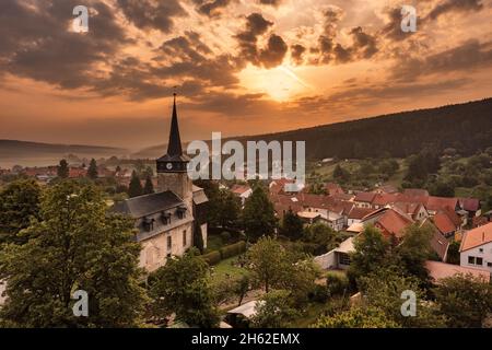 germany,thuringia,ilmenau,bücheloh,church,village,overview,sunrise,sun shines through thin layer of cloud,back light Stock Photo