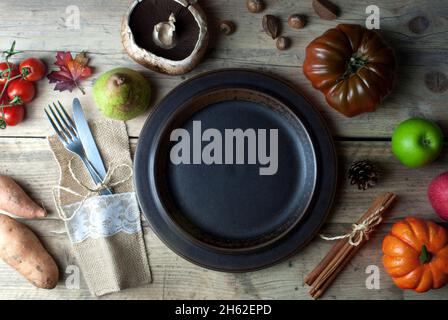 Thanksgiving dinner plate with cutlery on wooden table Stock Photo