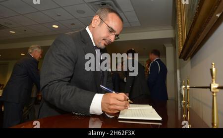 Prince Salman bin Hamad al Khalifa, foreground, the crown prince and first deputy prime minister of Bahrain, signs a guest book June 7, 2013
