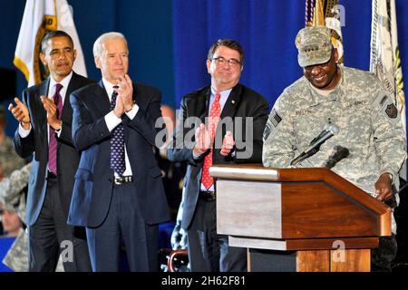 From left, President Barack Obama, Vice President Joe Biden and Deputy Secretary of Defense Ashton B. Carter applaude as Chairman of the Joint Chiefs of Staff General Martin E. Dempsey, far right, turns the podium over to General Lloyd James Austin III welcome members of the military from Iraq at Joint Base Andrews (Hangar 3) on Tuesday, December 20, 2011. Stock Photo