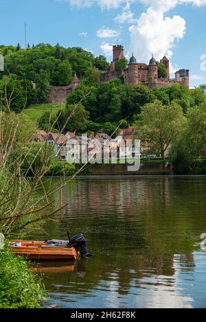 view from kreuzwertheim in bavaria over the main to wertheim castle in baden-wuerttemberg,a small motorboat lies on the bank in the reeds Stock Photo