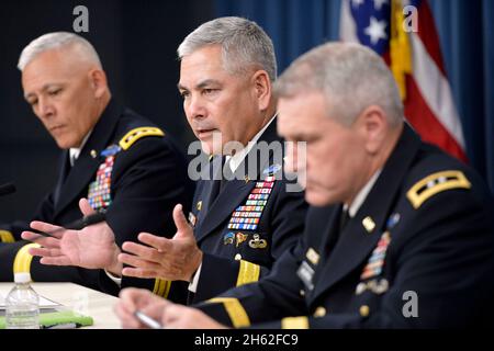 U.S. Army Gen. John Campbell, center, briefs the media on specific impending cuts and realignments within the Army's force structure during a press conference June 25, 2013. Stock Photo