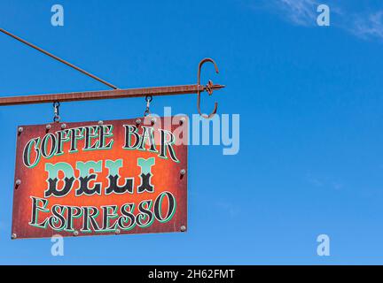 Tonopah, Nevada, US - May 16, 2011: Closeup of colorful Metal name board outside Coffee Bar Deli Espresso against blue sky. Stock Photo