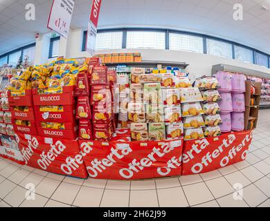 Turin, Italy - November 12, 2021: shelf with sale on offer of panettone and pandoro of famous brands Balocco, Maina, Bauli in supermarket Stock Photo