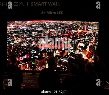 Trade show attendees view Chinese electronics manufacturer Konka exhibiting their Aphaea Smart Wall 8K Micro LED TV at CES Las Vegas, NV, USA Stock Photo