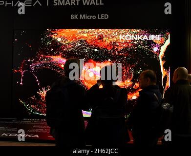 Trade show attendees view Chinese electronics manufacturer Konka exhibiting their Aphaea Smart Wall 8K Micro LED TV at CES Las Vegas, NV, USA Stock Photo