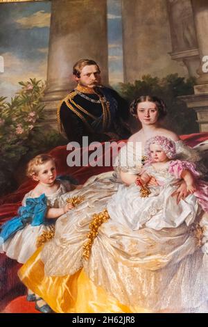 england,isle of wight,east cowes,osborne house,the palatial former home of queen victoria and prince albert,the dining room,painting of the family of crown prince and crown princess frederick william of prussia by franz xaver dated 1862 Stock Photo