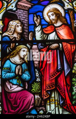 england,hampshire,new forest,ringwood,parish church of st.peter and st.paul,stained glass windows depicting biblical scenes Stock Photo