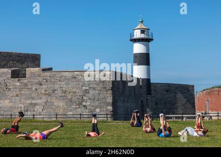 england,hampshire,portsmouth,southsea,men and women exeercising in front of southsea castle Stock Photo