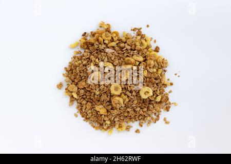 crunchy granola, muesli pile with nuts and fruits isolated on white background, top view, food concept Stock Photo