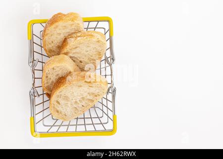 slices of french baguette inshopping basket isolated on white background, top view, concept bakery, sale of bread Stock Photo