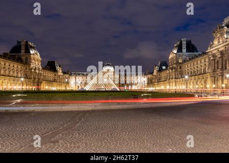 france,ile-de-france,paris,glass pyramid in the courtyard of the palais du louvre,light trails from cars Stock Photo