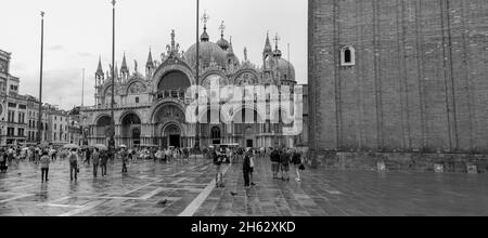 view of basilica di san marco and on piazza san marco in venice,italy. architecture and landmark of venice. cityscape of venice during rain. Stock Photo