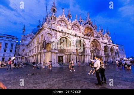 fantastic night on san marco square with campanile and saint mark's basilica. colorful evening cityscape of venice,italy,europe with a lot of reflecting water. Stock Photo