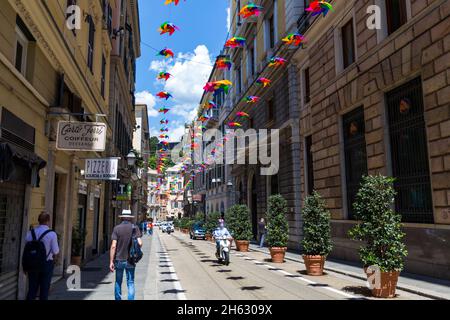 via roma street in genoa,italy,decorated with colorful umbrellas on top Stock Photo