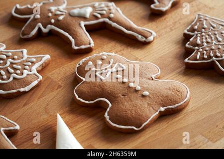 Decoration of gingerbread Christmas cookies in the form of a man, trees and animals with icing Stock Photo