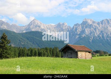 hay barn in the humpback meadows near mittenwald,karwendel,karwendel mountains,cloud mood,werdenfelser land,upper bavaria,bavaria,germany Stock Photo