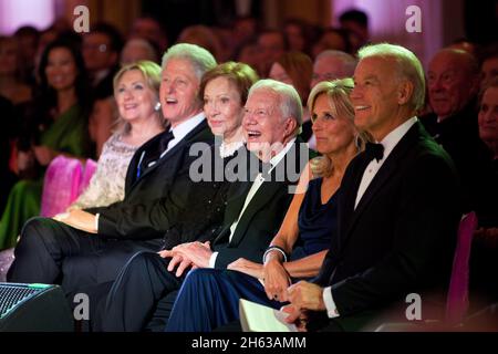 From left, Secretary of State Hillary Rodham Clinton, former President Bill Clinton, former First Lady Rosalynn Carter, former President Jimmy Carter, Dr. Jill Biden, and Vice President Joe Biden listen to performers during the State Dinner reception in the East Room of the White House, Jan. 19, 2011. Stock Photo