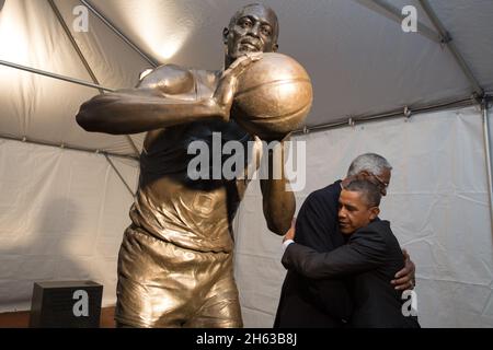 President Barack Obama is greeted by Bill Russell during a stop to view the statue of Russell at City Hall Plaza in Boston, Mass., Oct. 30, 2013. Stock Photo