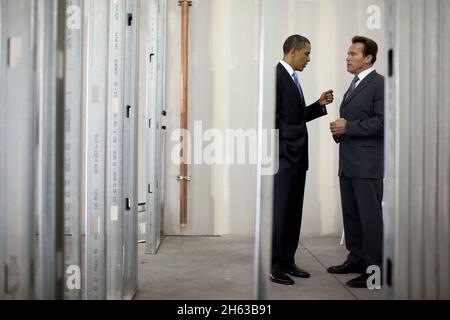 President Barack Obama talks with California Gov. Arnold Schwarzenegger during a tour of Solyndra, Inc., in Fremont, Calif., May 26, 2010. Stock Photo