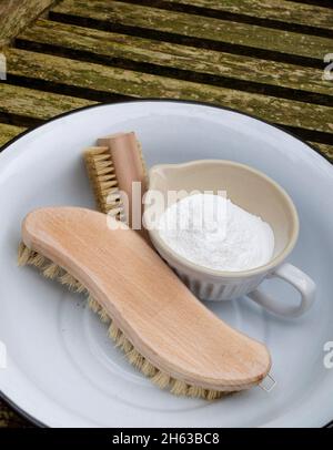 clean garden furniture after winter; soda (baking soda),brush and bowl Stock Photo