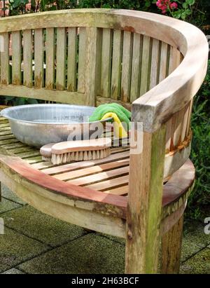 clean garden furniture after winter; soda (baking soda),brush and bowl Stock Photo