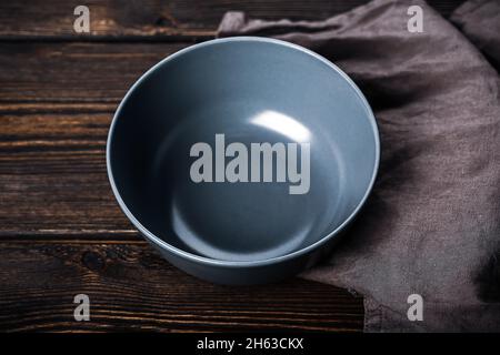 Empty gray plate on a wooden background. Kitchen mockup Stock Photo