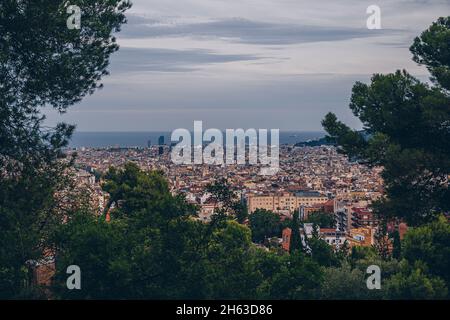 view to downtown barcelona from antoni gaudi's artistic park guell in barcelona,spain. this modernistic park was built between 1900 and 1914 and is a popular tourist attraction. Stock Photo
