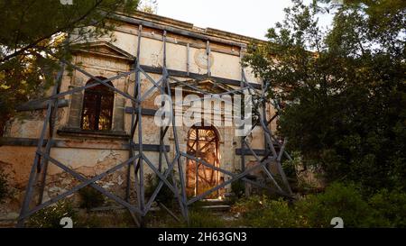 greece,greek islands,ionian islands,kefalonia,southeast coast,sissia monastery,abandoned,13th century ad francis of assisi,ruins,lonely,portal and front of the old monastery,beaten with boards Stock Photo