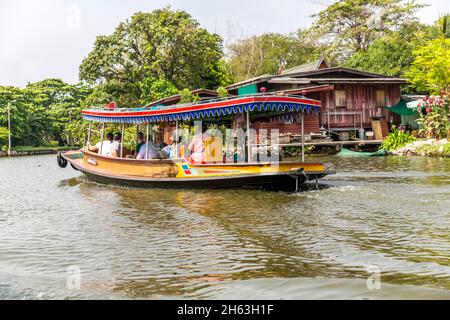 colorful longtail boat with tourists,khlongs,khlong ride on the canals of bangkok,bangkok,thailand,asia Stock Photo