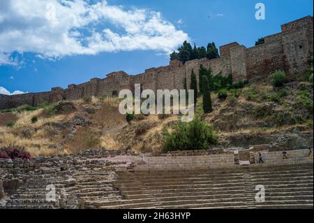 malaga,andalusia,spain: ancient ruins of roman theater (el teatro romano) at foot of famous alcazaba fortress. roman theater is oldest monument in malaga city,it was built in first century bc.
