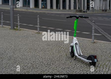 germany,berlin,august 17,2021,incorrectly parked e-scooter on a sidewalk in the early morning in berlin,unsightly sight in berlin's city center,big problem in berlin Stock Photo