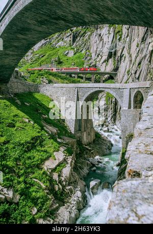 devil's bridge over the reuss in the schöllenen gorge with the schöllenenbahn,andermatt,canton of uri,switzerland Stock Photo