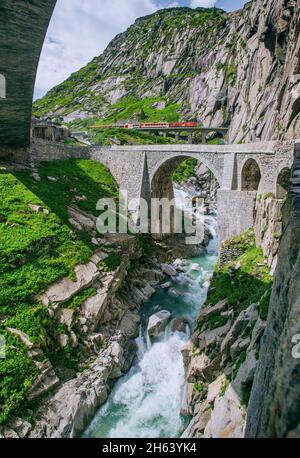 devil's bridge over the reuss in the schöllenen gorge with the schöllenenbahn,andermatt,canton of uri,switzerland Stock Photo