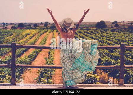 Beautiful young hipster girl in stylish vintage outfit standing