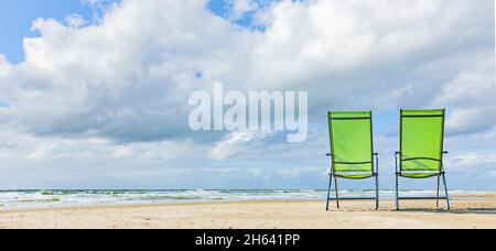 sun chairs on the beach with blue sea Stock Photo