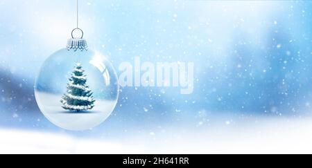 translucent glass christmas ball with a fir tree in front of a blurred background Stock Photo