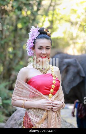 Woman wears thai dress with her elephant Stock Photo