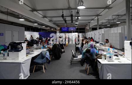 Glasgow, UK. 12th Nov, 2021. Members of the press are at work during the 26th session of the Conference of the Parties (COP26) to the United Nations Framework Convention on Climate Change in Glasgow, United Kingdom, on Nov. 12, 2021. Alok Sharma, president of the ongoing United Nations climate change conference in Glasgow, Scotland, said Friday that he expected the negotiations for a deal will continue into Saturday afternoon. The two-week COP26 was originally scheduled to end on Friday. Credit: Han Yan/Xinhua/Alamy Live News Stock Photo